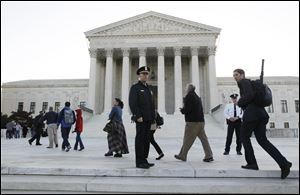 Members of the public line up as the Supreme Court begins three days of arguments on the health care reform law signed by President Obama in Washington, D.C. Monday.