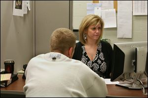 Melissa Schaller takes information from a client at Rescue Inc., the area's only emergency mental health center. It faces a 15 percent cut from the county's Mental Health and Recovery Services Board.