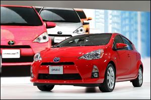 The Toyota Prius c is almost 20 inches shorter than the classic Prius hatchback. It also is about two inches narrower and shorter. Toyota says the vehicle gets about 50 miles to the gallon.
