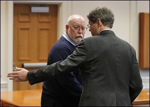 John Tucker of Flint, Mich., left, appears in Maumee Municipal Court with attorney George Gerken. 