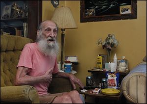 Dallas Watts, 78, indicates where he was kicked during an assault that took place in East Toledo on Saturday. He said there were six boys, the youngest one 11 years old.