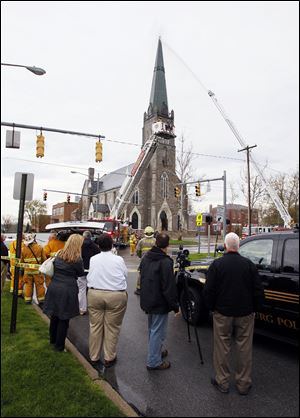 Spectators observe the firefighters’ efforts to extinguish the blaze.