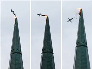 St. Rose Church’s cross topples after being hit by lightning.
