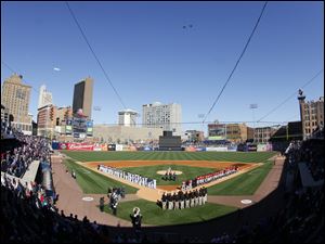 A pair of F16s from the 180th Fighter Wing fly over Fifth Third field before the start of the game.