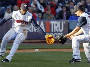 Toledo third baseman Audy Ciriaco (16) and pitcher Brayan Villarreal (43) field a hit against Indianapolis during the sixth inning.