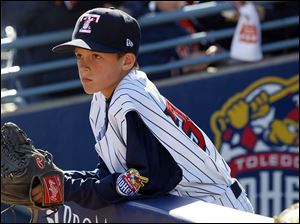 Kyle Nevin, 10, son of Mud Hens' manger Phil Nevin, waits for the game to start.