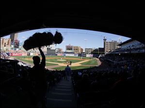 A vendor walks through the aisle selling cotton candy as the Toledo Mud Hens play the Indianapolis Indians.