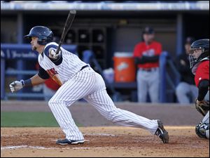 Toledo Mud Hens player Jerad Head (13) hits a single to score Ryan Strieby in the seventh inning.