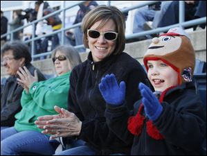 Sarah Bucher, of Perrysburg, and her son Lincoln Bucher, 4, cheer as the Toledo Mud Hens are introduced
