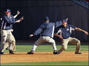The Toledo Mud Hens grounds crew dances as they groom the infield during the fifth inning.