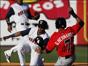 Mud Hens second baseman Eric Patterson (3) tags out  Indianapolis' Gorkys Hernandez (7) during the sixth inning.