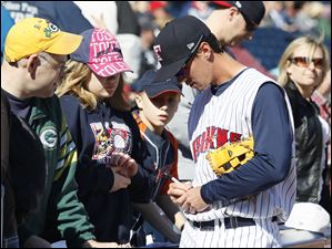 Mud Hens' Brent Dlugach signs autographs for fans.
