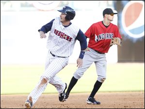 Toledo Mud Hens player Ryan Strieby (34) rounds second on his way to third on a double by teammate Brad Eldred in the seventh inning.