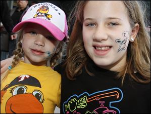 Morgan Hoverman, 4, and her sister Hannah Hoverman, 8, are decked out in Mud Hens gear as they prepare to cheer on Toledo.