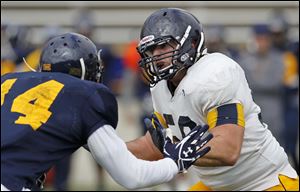 University of Toledo offensive lineman Josh Hendershot (56), right, gets his chance as a starter this year.