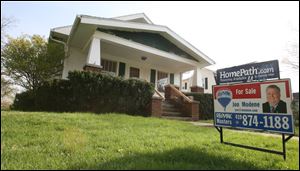 Jon Modene, a foreclosure specialist at ReMax Masters in Perrysburg, said his company sometimes uses the Homepath moniker on signs to denote a property repossessed by Fannie Mae, like this house on East Fifth Street in Perrysburg.
