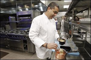 Celebrity chef Michael Mina prepares his signature dish lobster pot pie at his restaurant Saltwater at the MGM Grand Detroit.