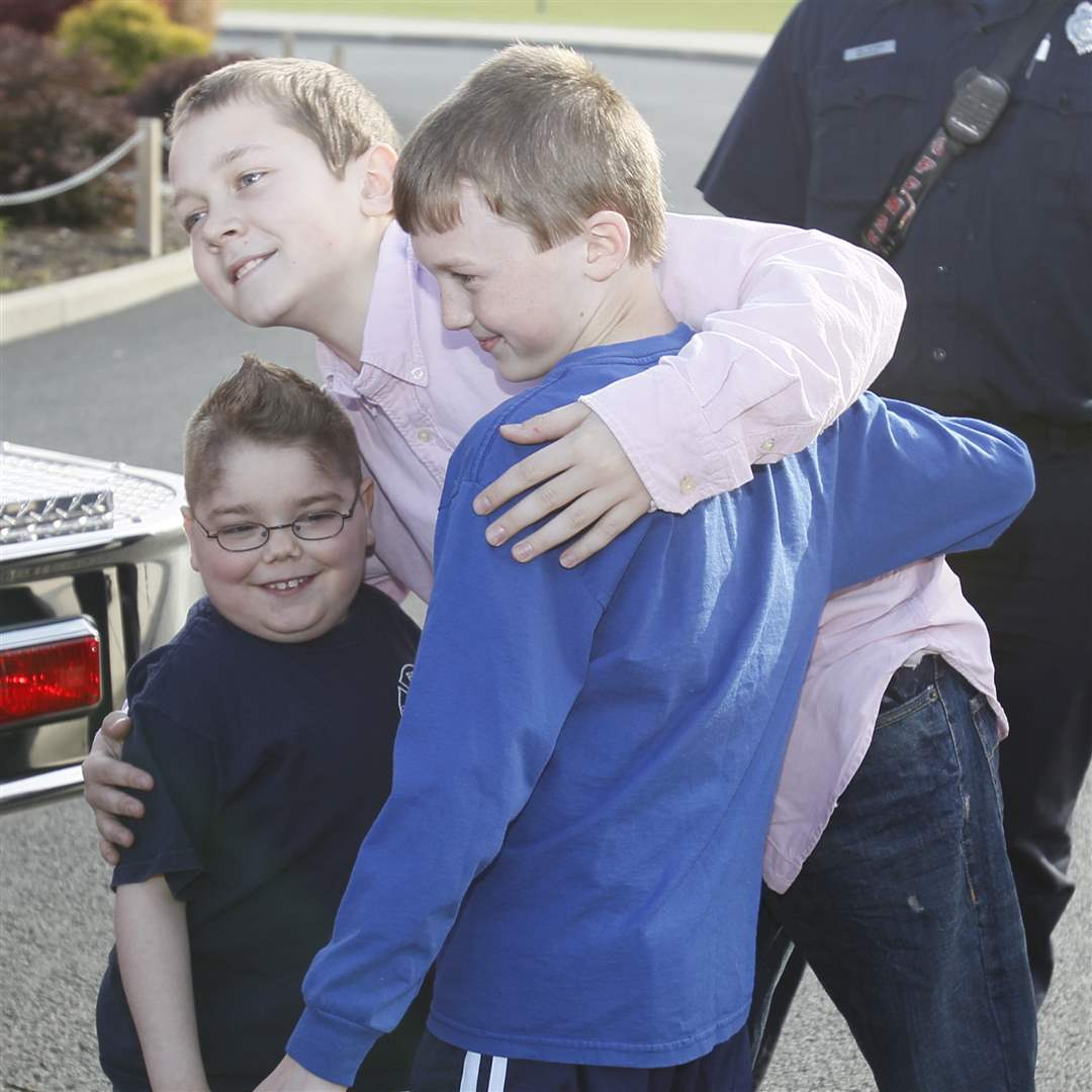 Hunter-Bute-left-gives-a-hug-to-Noah-Brice-9-of-Perrysburg