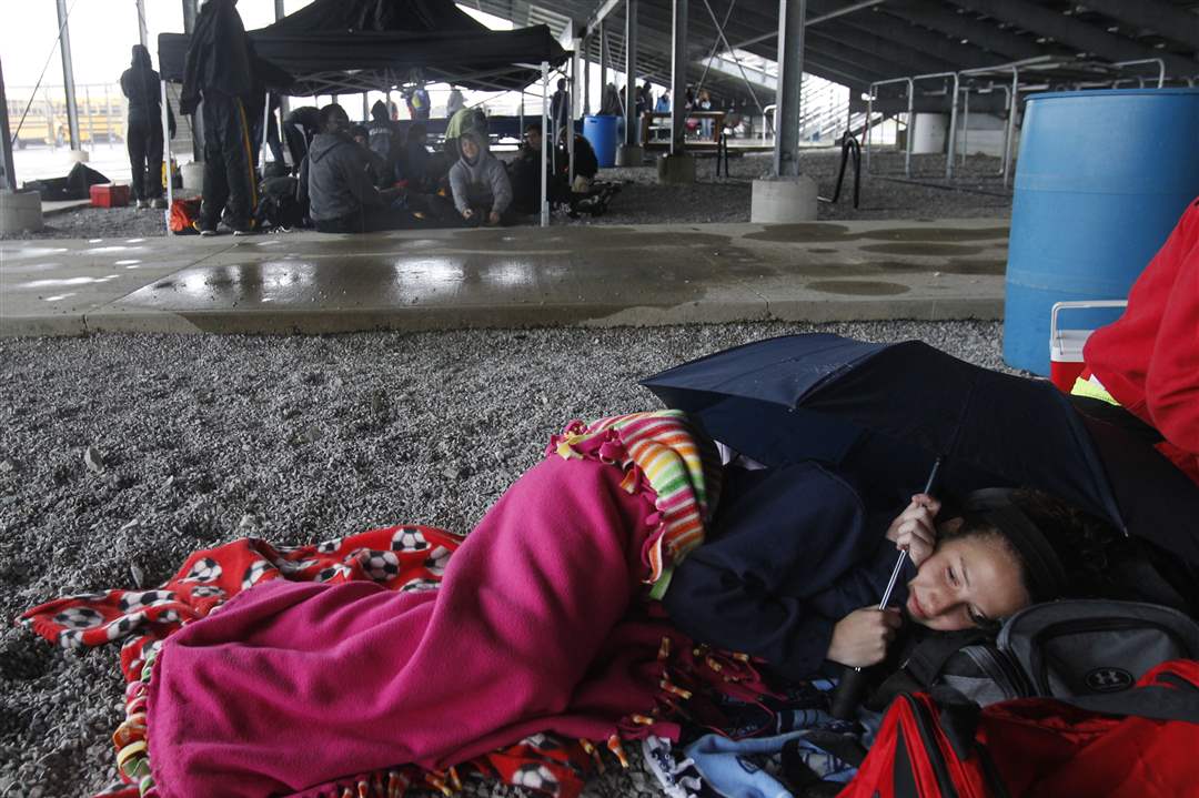 Wauseon-runner-Brittany-Wills-rests-under-wet-bleachers