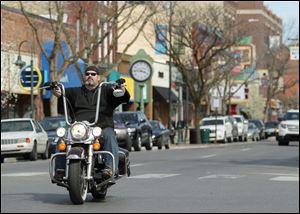 A motorcyclist in Traverse City legally rides without a helmet after Michigan Gov. Rick Snyder signed the repeal of mandatory helmets into law.