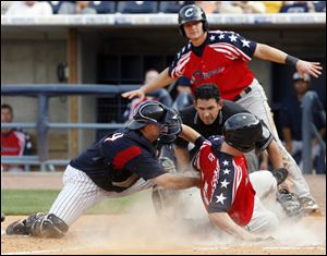 Mud Hens catcher Jeff Kunkel, left front, will serve as the Detroit Tigers' bullpen catcher.