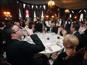 Steve Szuch and his sister Kim Szuch enjoy the meal to benefit the Maritime Academy of Toledo Foundation.