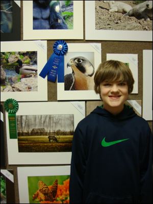Alex Lenhart, 12, of Rocky River, Ohio, shows off his winning submission in the Fauna category. He has taken photography lessons through the Toledo Metroparks.