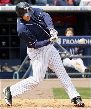 Mud Hens designated hitter Brad Eldred (44) breaks his bat on a single RBI against the Columbus Clippers during the third inning Sunday at Fifth Third Field in Toledo, Ohio.