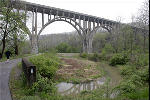 A man walks along the tow path approaching the Station Road Bridge at the Cuyahoga Valley National Park in Brecksville, Ohio, which the FBI says was targeted in a terrorism plot.