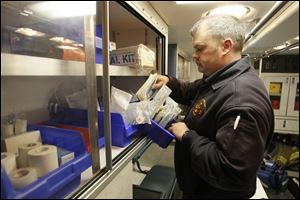 Lt. Brian Dempsey stocks the ambulance at Northwood Fire Station No. 2. The increase in the fire department's budget has helped the department's operations, Chief Joel Whitmore said.