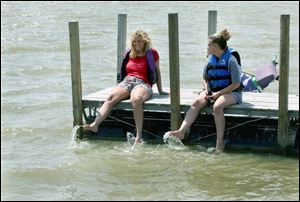 Carrie Williamson of Point Place and Sarah Grosjean of Oregon enjoy warm temperatures at Ed Cullen Park.