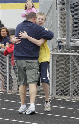 Washington Local Schools superintendent Patrick Hickey congratulates his son Noah Hickey.