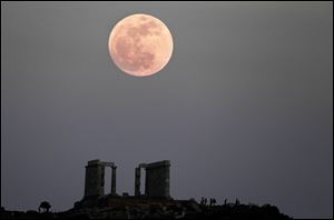 The full moon rises behind the Temple of Poseidon in Cape Sounion, southeast of Athens. The so-called 'super moon' is as much as 14 percent larger and 30 percent brighter than other full moons.