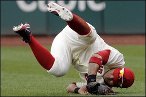 Cleveland Indians right fielder Shin-Soo Choo rolls upside down after catching a fly ball by Texas Rangers pinch hitter Adrian Beltre in the ninth inning of a baseball game in Cleveland today. The Indians won 4-2. 