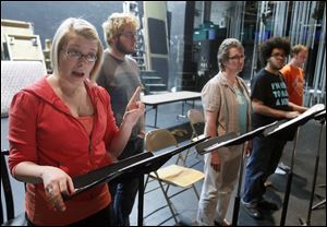 Katelyn Houg, left, Nick Comer, Sandy Kimmel, Ben Jones, and Eric Gobel work on a scene from ‘Market and Washington: In Tiffin’s Own Words,’ a play about community that was inspired by the debate surrounding the Seneca County Courthouse.