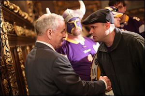 A Vikings fan thanked Gov. Mark Dayton, left, after the stadium bill passed in the House Monday night. 