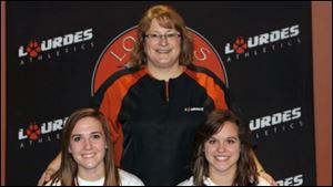 Megan Mosiniak of Evergreen High School, left, and Brianna Meg- yesi of Anthony Wayne High School are among the 10 players signed so far by coach Jo Ann Gordon, center, to play at Lourdes University.