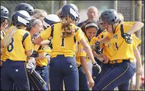 Notre Dame's Cassie Gillespie (14) celebrates with her teammates after hitting a three-run home run in a win over Clay. Gillespie also earned the win on the mound as Notre Dame won a sectional final crown.