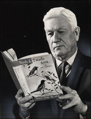 Lou Campbell peruses a copy of his 1968 book, 'Birds of the Toledo Area.' He began researching and documenting the bird population in the Toledo area in 1926, and in 1940 he crafted a comprehensive guide called 'The Birds of Lucas County,' which was published by the Toledo Zoological Society. The 1968 updated and revised text was published by The Blade.