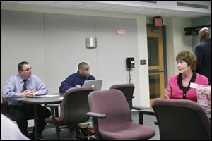 Jim Gault, left, TPS' chief academic officer, and James Gant, TPS business officer, chat with Mary Ronan, Cincinnati Public Schools superintendent, during a visit by TPS officials and employees to the Cincinnati district last month. 
