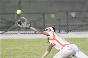 Left fielder Chelsea Zoltowski miss plays a fly ball hit by pitcher Cassie Gillespie, scoring two runs for Notre Dame Academy. 