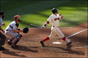 Cleveland Indians' Jason Kipnis, right, watches his RBI sacrifice fly against the Miami Marlins in the fifth inning of an interleague baseball game in Cleveland, Saturday. 
