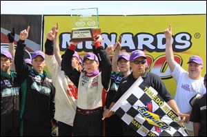 Chris Buescher celebrates with the Menards 200 trophy after beating Frank Kimmel to the finish line by .114 seconds Sunday afternoon.