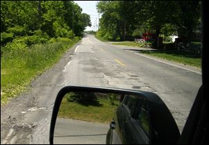 The stretch between Quail Hollow Drive and Adler Road is described as a safety issue as well as an eyesore.