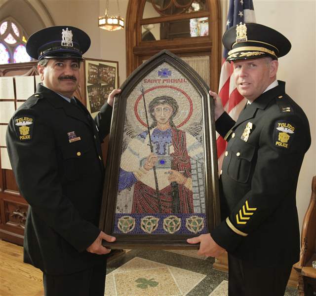 Patrolman-Vince-Manera-Captain-George-Kral-hold-St-Michael-the-Archangel