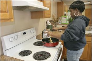 Paris May, 23, cooks a scrambled-egg dish at Seagate Food Bank’s cooking class. Ms. May said she knows how to cook but has mostly prepared fried foods.
