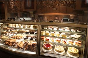 Workers fill a dessert case at the Epic Buffet inside the Hollywood Casino.