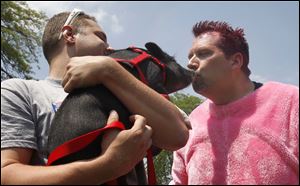 Jack Renz, the principal at East Broadway Elementary School, kisses Ned, a miniature pig, in front of the entire student body outside of their Toledo, Ohio school.