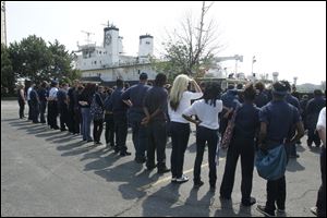 Students watch as the training vessel State of Michigan docks at the Maritime Academy of Toledo. The Michigan, which is operated out of the Great Lakes Maritime Academy in Traverse City, arrived Friday. Those in training aboard the vessel got to visit with the Toledo students to talk about maritime education and career opportunities, and they gave tours of the 224-foot former Navy submarine surveillance ship. The Michigan was scheduled to leave today.