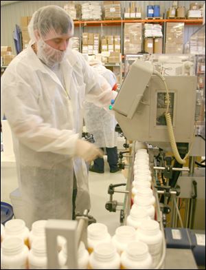 Dennis Vore works on the automatic line at the Uckele Health & Nutrition , Inc. plant in Blissfield Michigan.